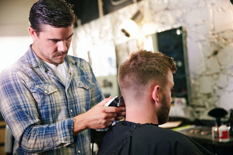 professional barber giving a clean haircut to customer